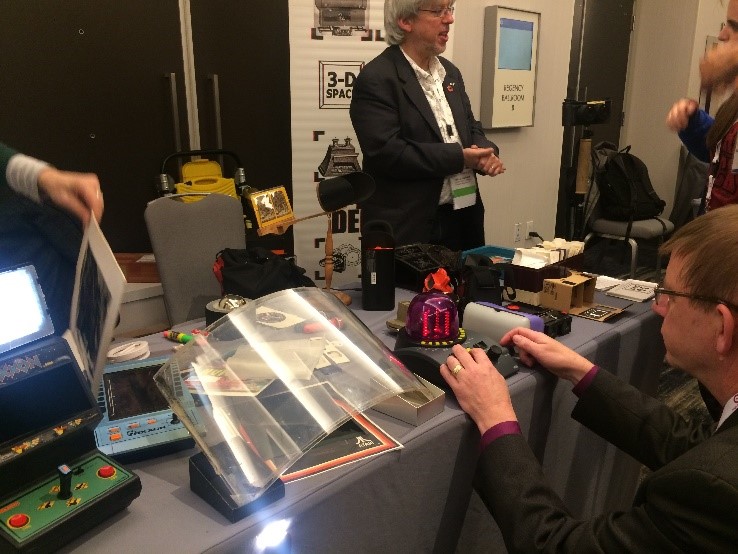 The demo session is always accompanied by a number of interesting discussions. Moreover, this photo contains three Google VR cardboards / HMDs – find them all! In the mid-frame is Andrew Woods in discussion with Guarav Sharma.